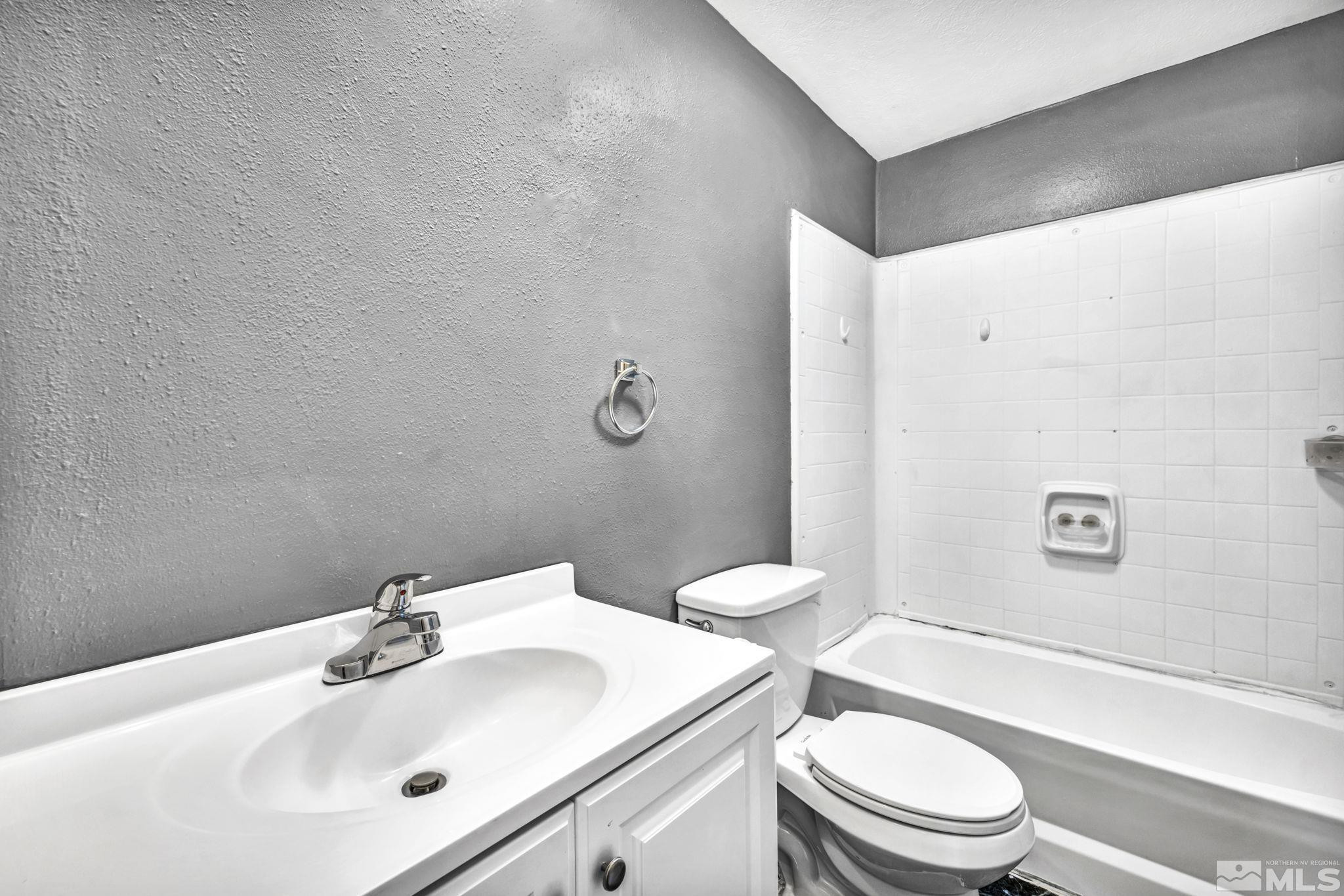 4770 Rampion Way Sun Valley, NV 89433 - Photo 13 of 17 a bathroom with a sink a toilet and shower