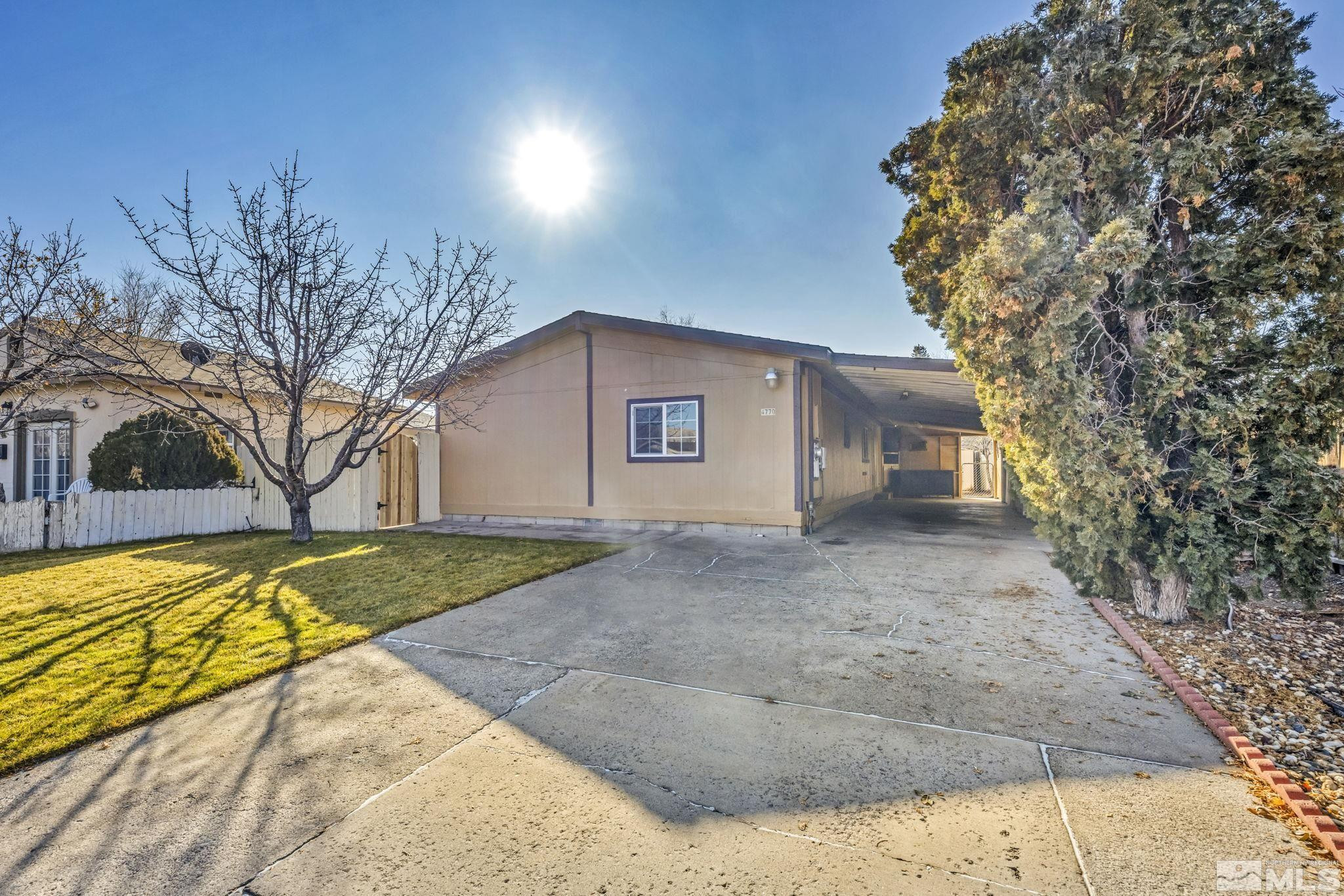 4770 Rampion Way Sun Valley, NV 89433 - Photo 17 of 17 a view of a house with a yard and garage