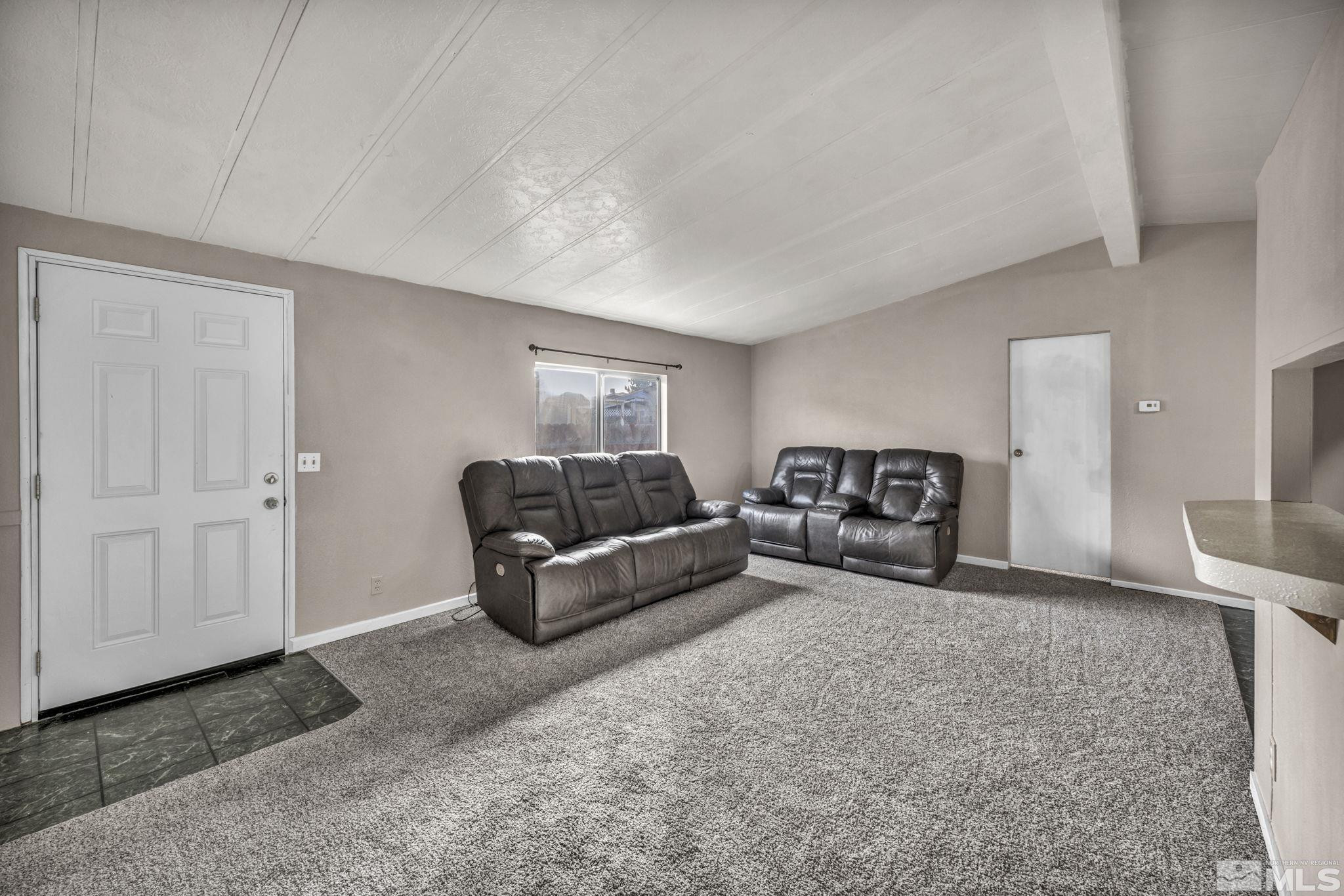 4770 Rampion Way Sun Valley, NV 89433 - Photo 4 of 17 a living room with furniture and a couch