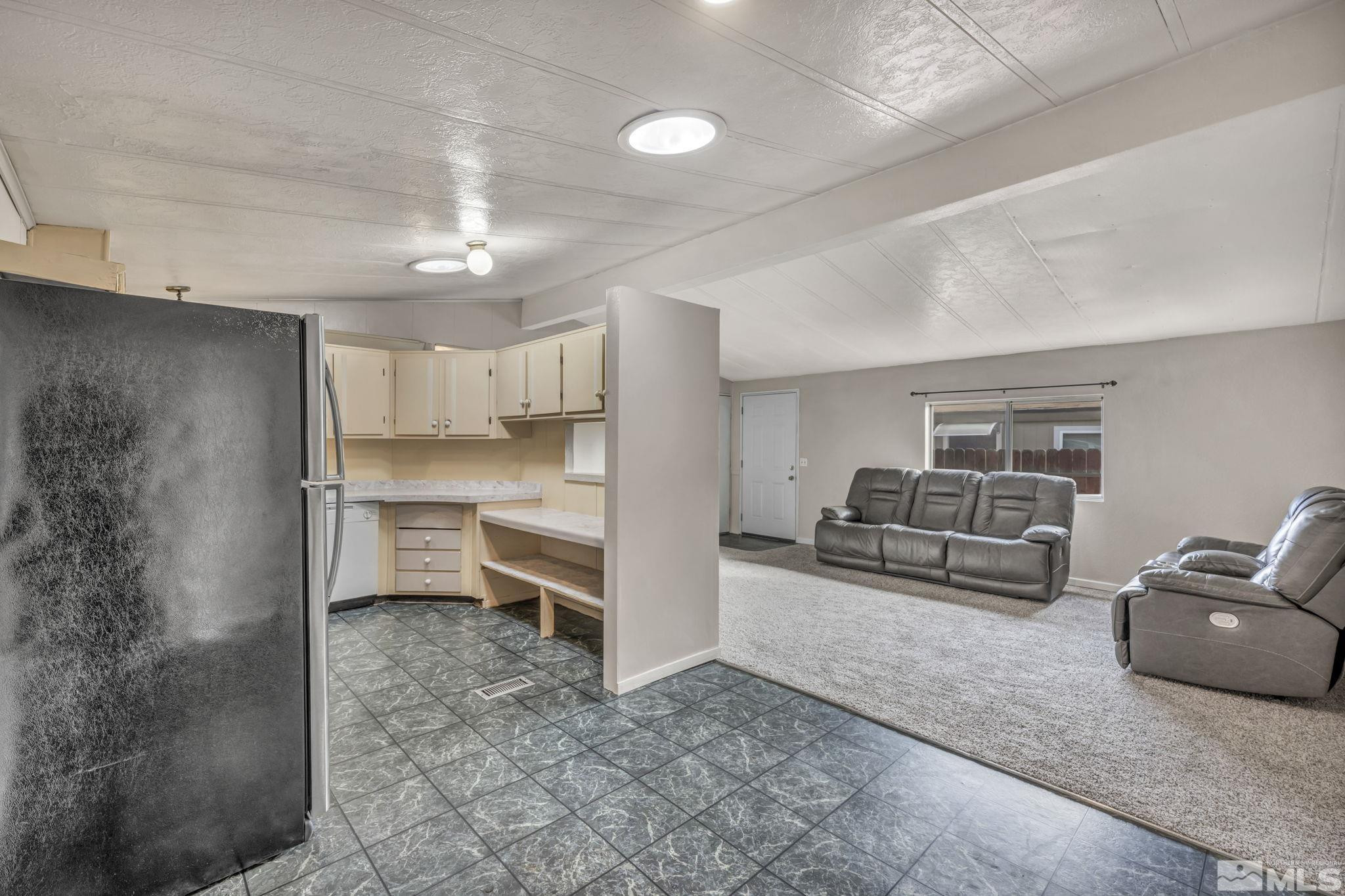 4770 Rampion Way Sun Valley, NV 89433 - Photo 7 of 17 a living room with furniture and white walls