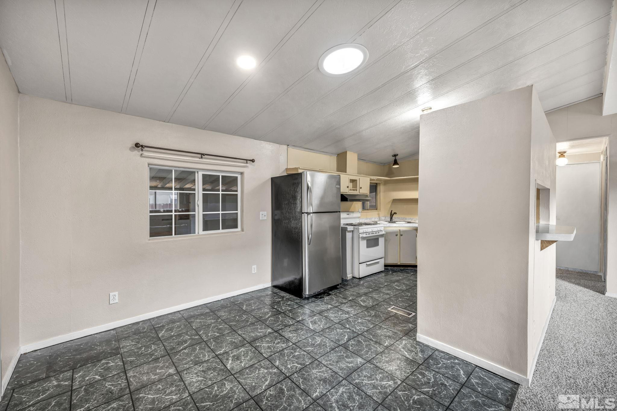 4770 Rampion Way Sun Valley, NV 89433 - Photo 8 of 17 a kitchen with refrigerator and cabinets