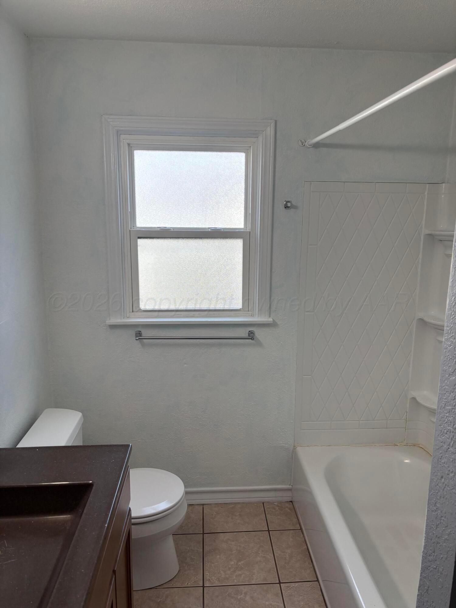 4014 Cline Road Amarillo, TX 79110 - Photo 11 of 21 a bathroom with a sink and a bathtub