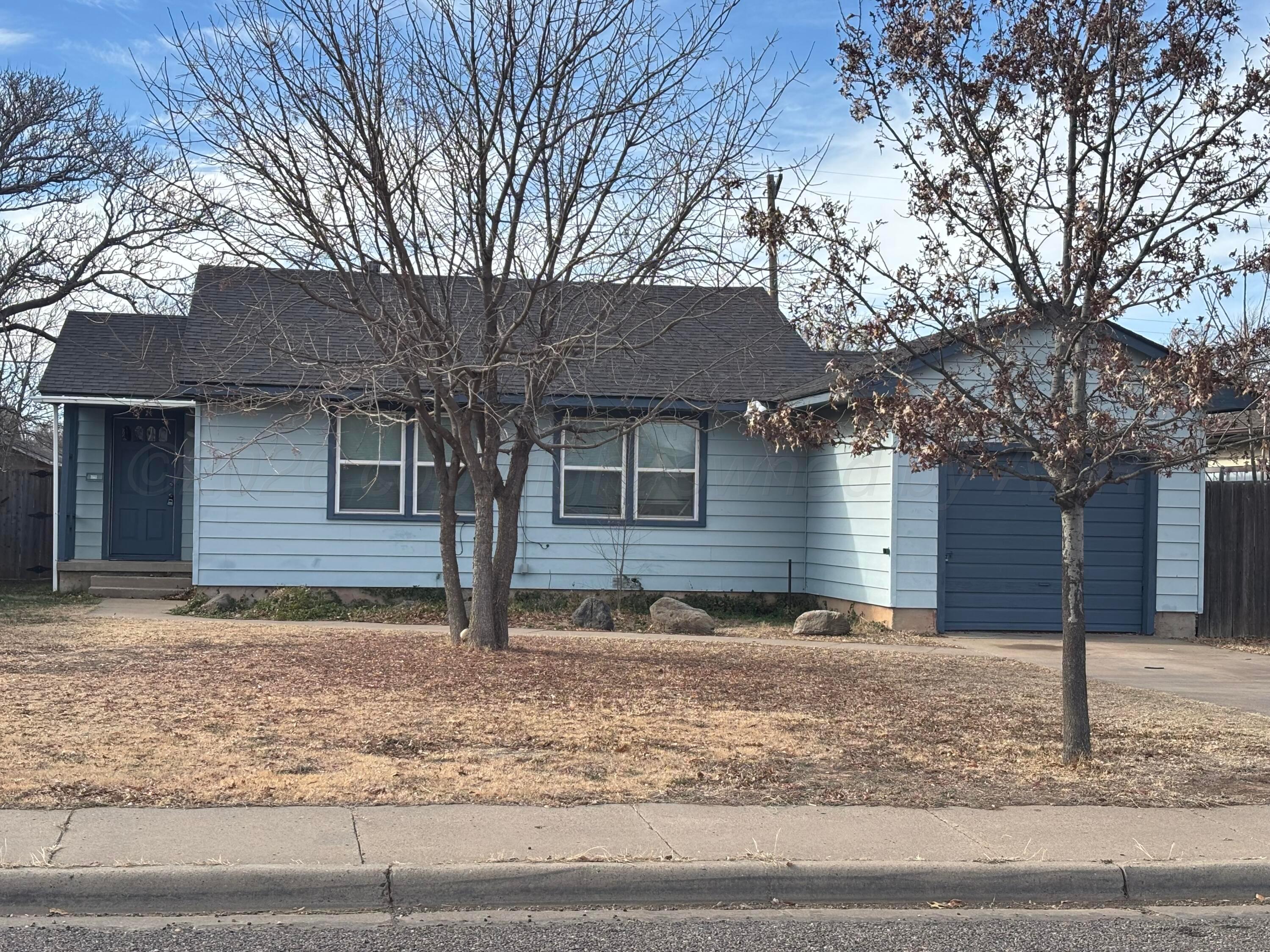 4014 Cline Road Amarillo, TX 79110 - Photo 2 of 21 a front view of a house with garden and trees