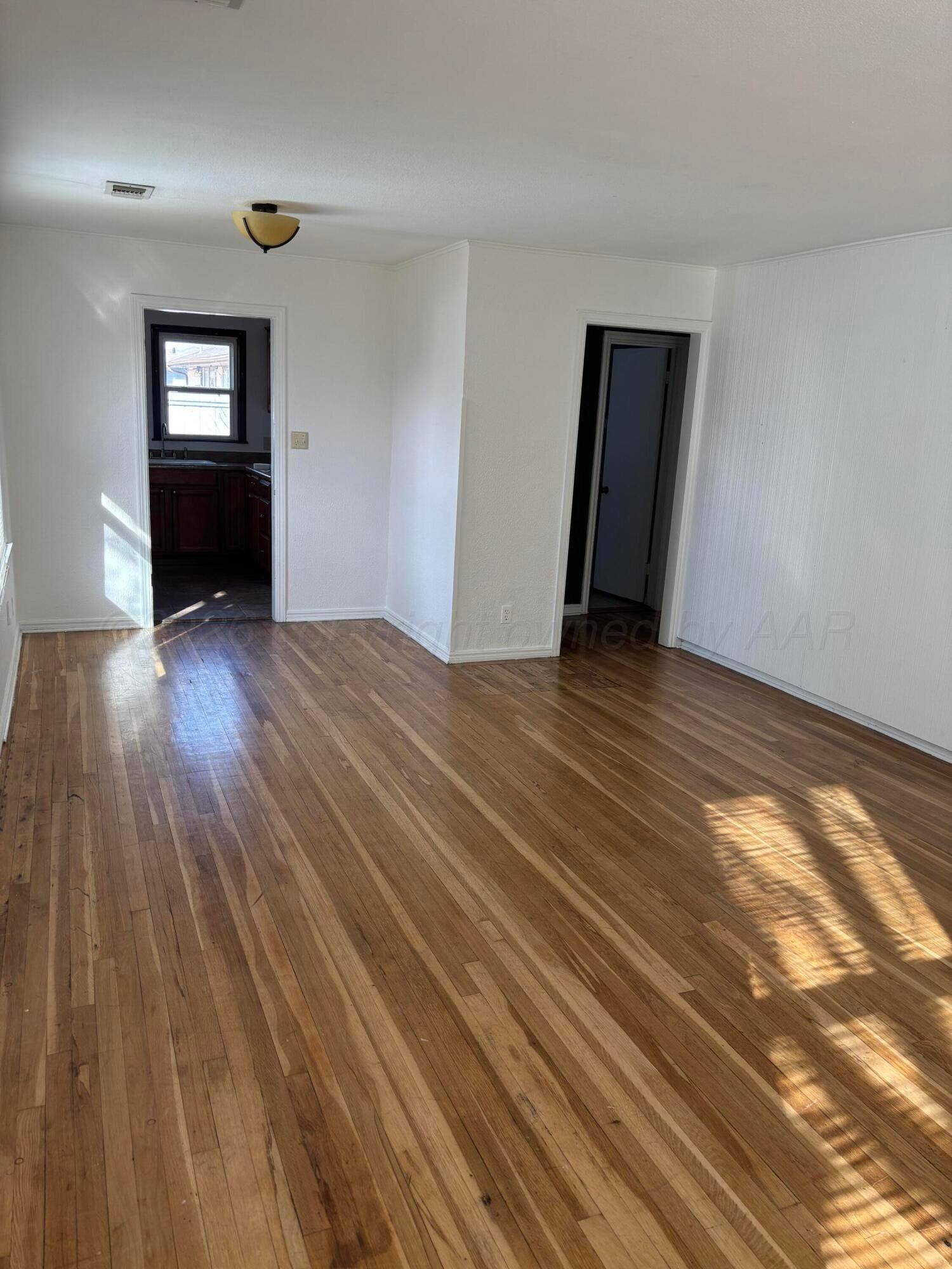 4014 Cline Road Amarillo, TX 79110 - Photo 4 of 21 a view of empty room with wooden floor
