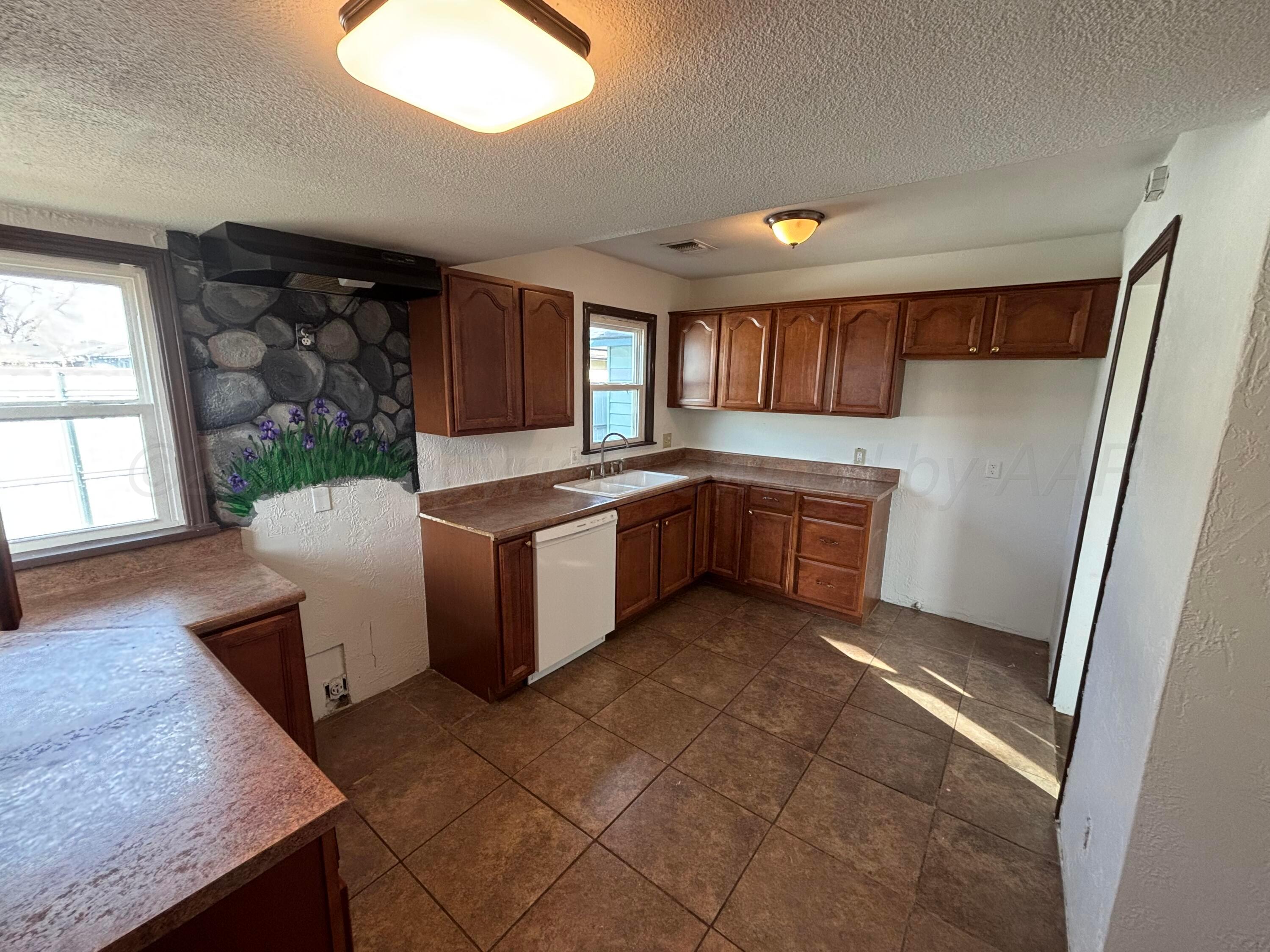 4014 Cline Road Amarillo, TX 79110 - Photo 5 of 21 a kitchen with granite countertop a sink stove and refrigerator