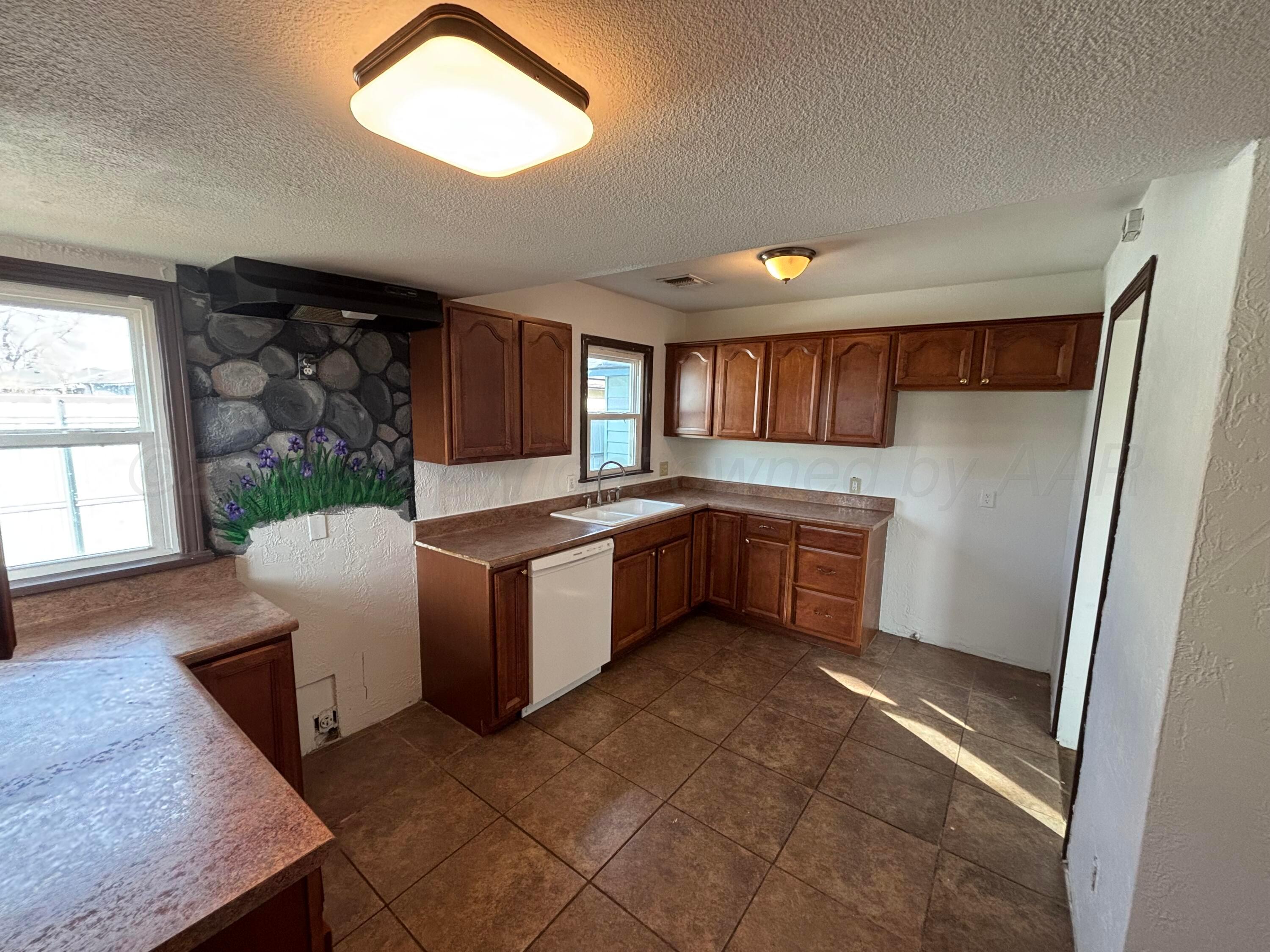 4014 Cline Road Amarillo, TX 79110 - Photo 6 of 21 a kitchen with a refrigerator and window