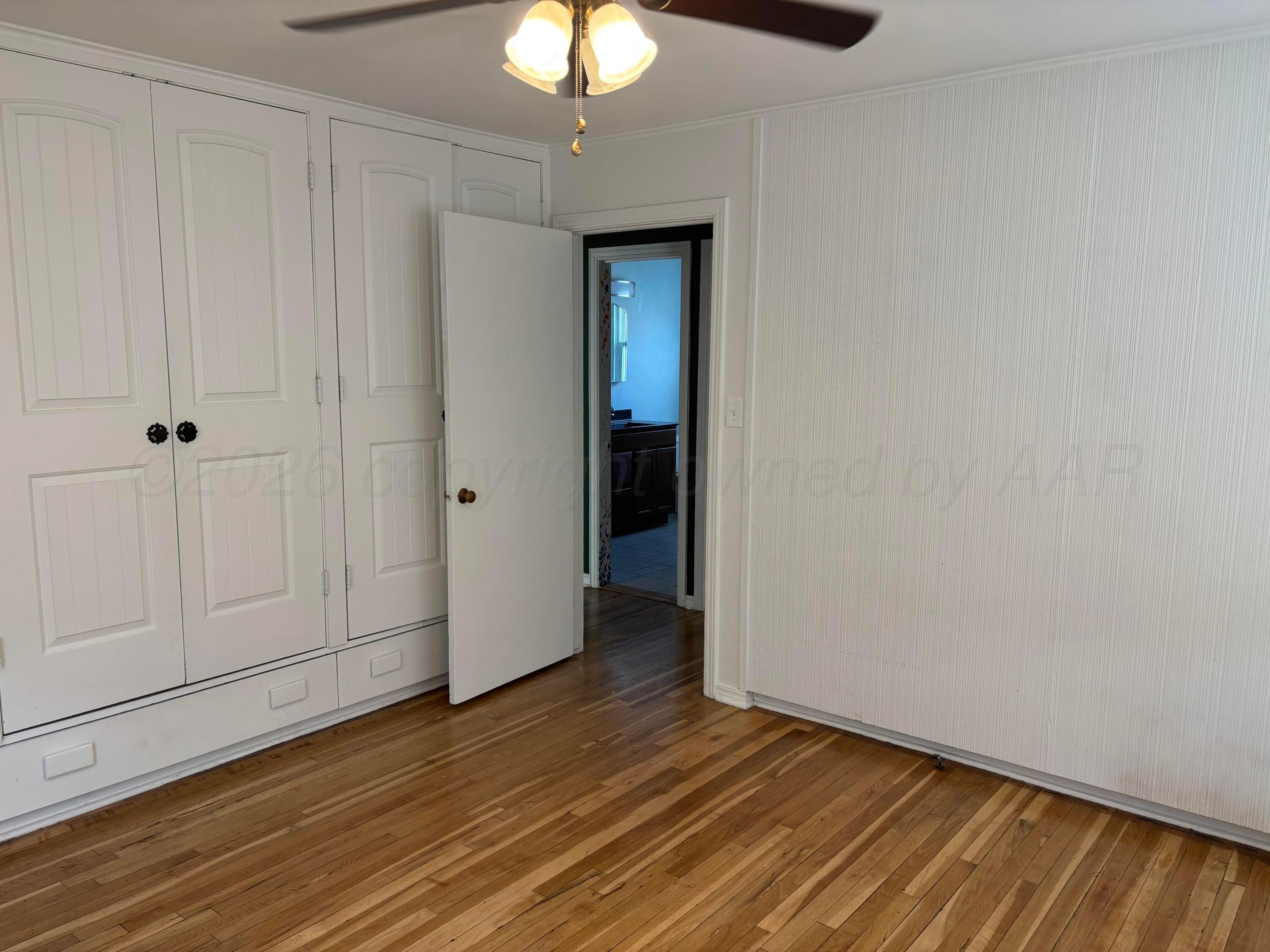 4014 Cline Road Amarillo, TX 79110 - Photo 8 of 21 a view of an empty room with wooden floor