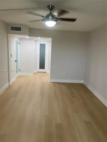an empty room with a empty space and a ceiling fan
