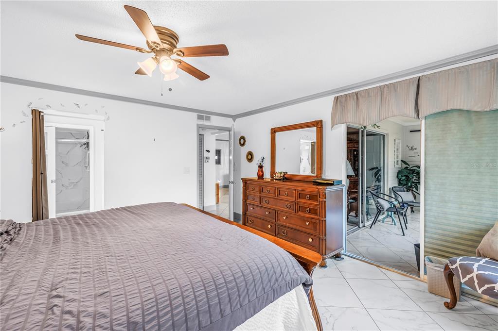 415 Spring Lakes Boulevard, Unit 415D Bradenton, FL 34210 - Photo 19 of 52 a bedroom with furniture and a ceiling fan