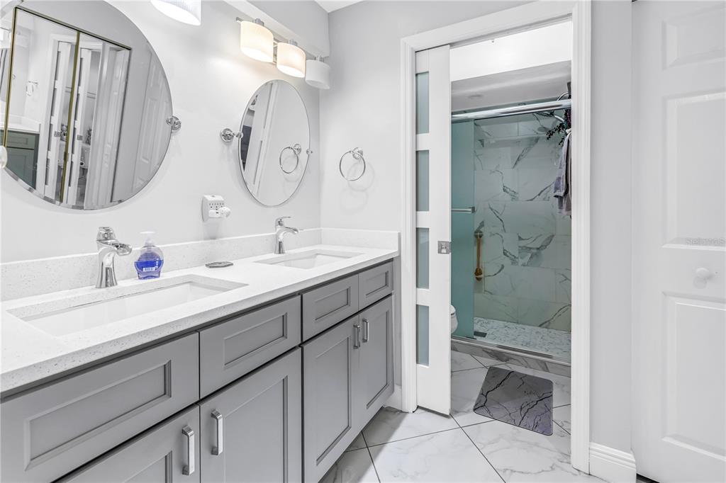 415 Spring Lakes Boulevard, Unit 415D Bradenton, FL 34210 - Photo 20 of 52 a bathroom with a double vanity sink mirror and toilet