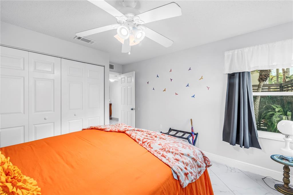 415 Spring Lakes Boulevard, Unit 415D Bradenton, FL 34210 - Photo 24 of 52 a bedroom with a bed and a chandelier