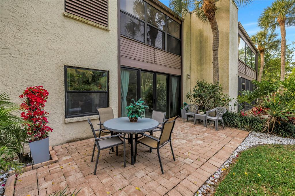 415 Spring Lakes Boulevard, Unit 415D Bradenton, FL 34210 - Photo 31 of 52 a view of a patio with a table and chairs in a patio