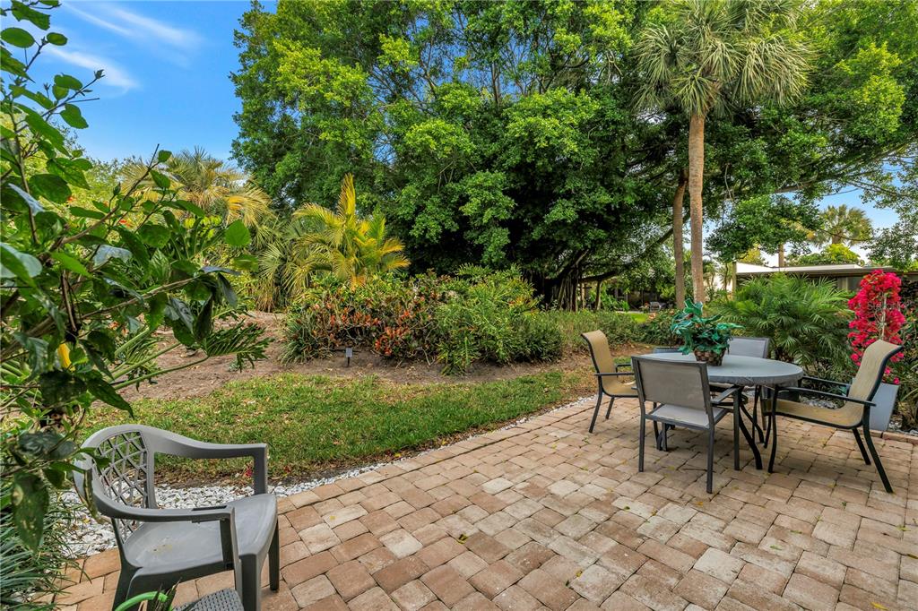 415 Spring Lakes Boulevard, Unit 415D Bradenton, FL 34210 - Photo 33 of 52 a view of a backyard with table and chairs and potted plants