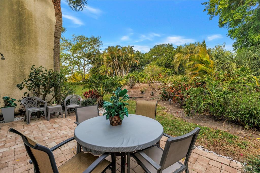 415 Spring Lakes Boulevard, Unit 415D Bradenton, FL 34210 - Photo 35 of 52 a backyard of a house with table and chairs