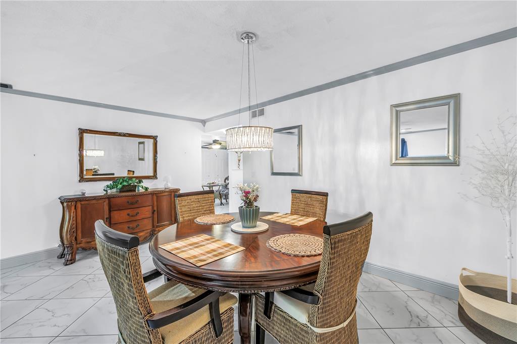 415 Spring Lakes Boulevard, Unit 415D Bradenton, FL 34210 - Photo 9 of 52 a view of a dining room with furniture