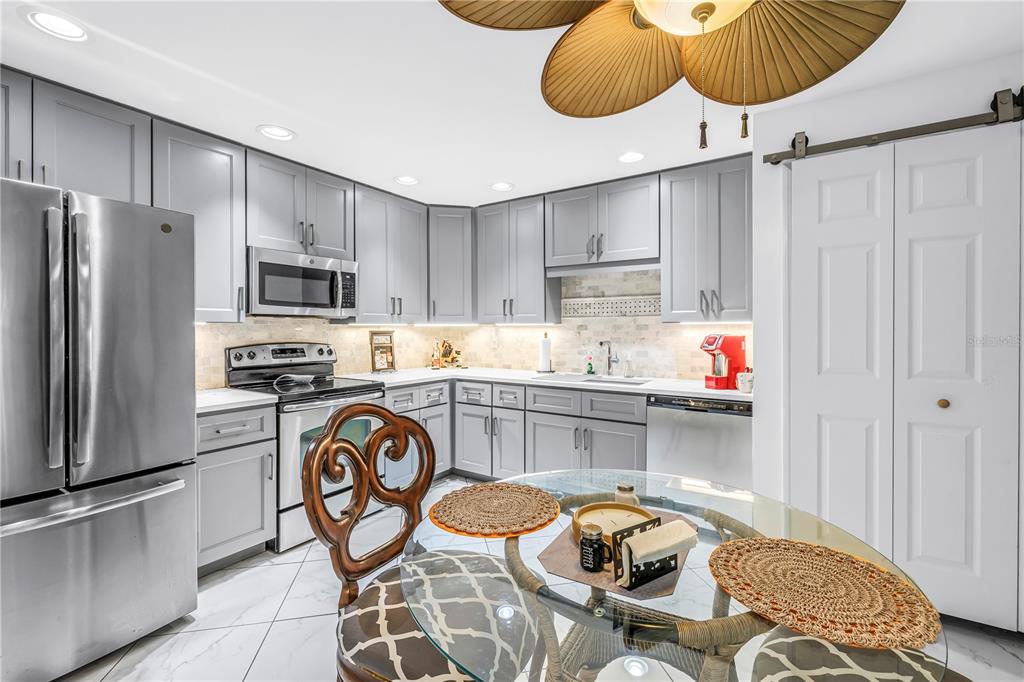 415 Spring Lakes Boulevard, Unit 415D Bradenton, FL 34210 - Photo 10 of 52 a kitchen with stainless steel appliances granite countertop a sink and a refrigerator
