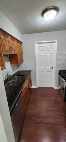 a kitchen with granite countertop a stove and a sink