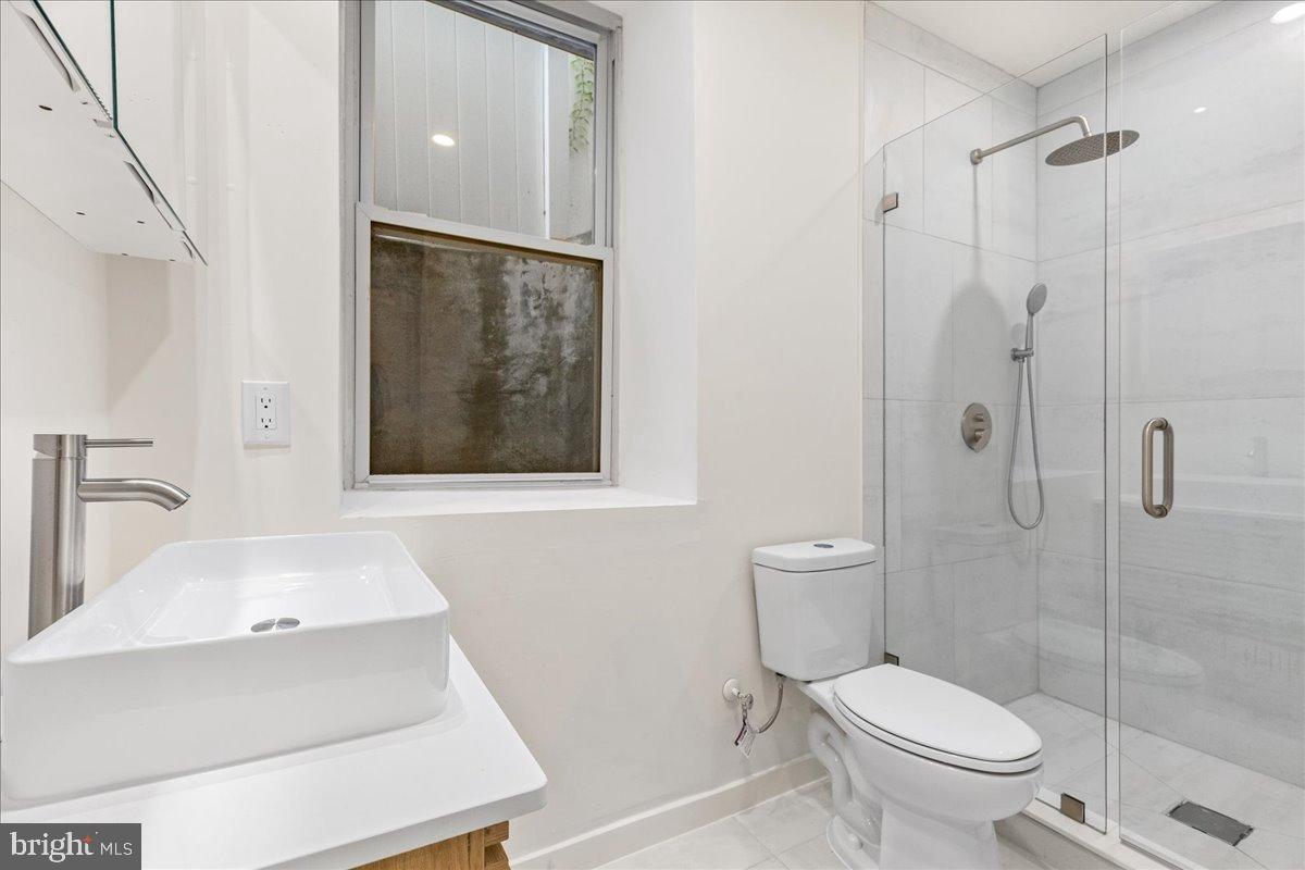 3907 Spring Garden Street, Unit 1 Philadelphia, PA 19104 - Photo 11 of 33 a bathroom with a sink toilet and shower