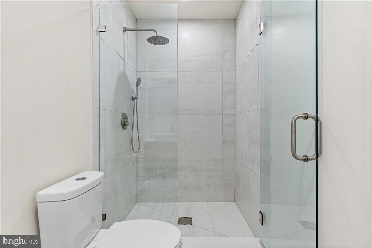 3907 Spring Garden Street, Unit 1 Philadelphia, PA 19104 - Photo 12 of 33 a bathroom with a shower and toilet