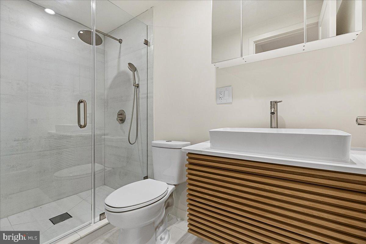 3907 Spring Garden Street, Unit 1 Philadelphia, PA 19104 - Photo 18 of 33 a bathroom with a sink a toilet and shower