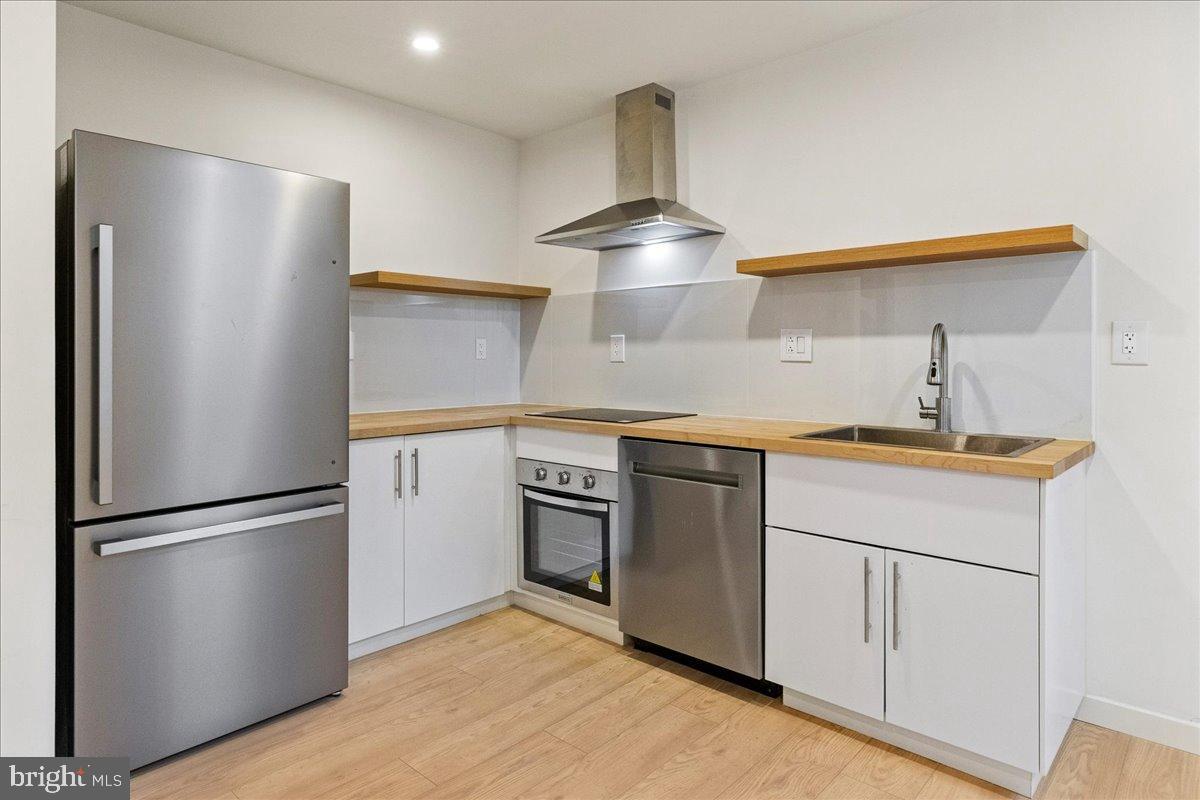 3907 Spring Garden Street, Unit 1 Philadelphia, PA 19104 - Photo 22 of 33 a kitchen with stainless steel appliances a refrigerator and a sink