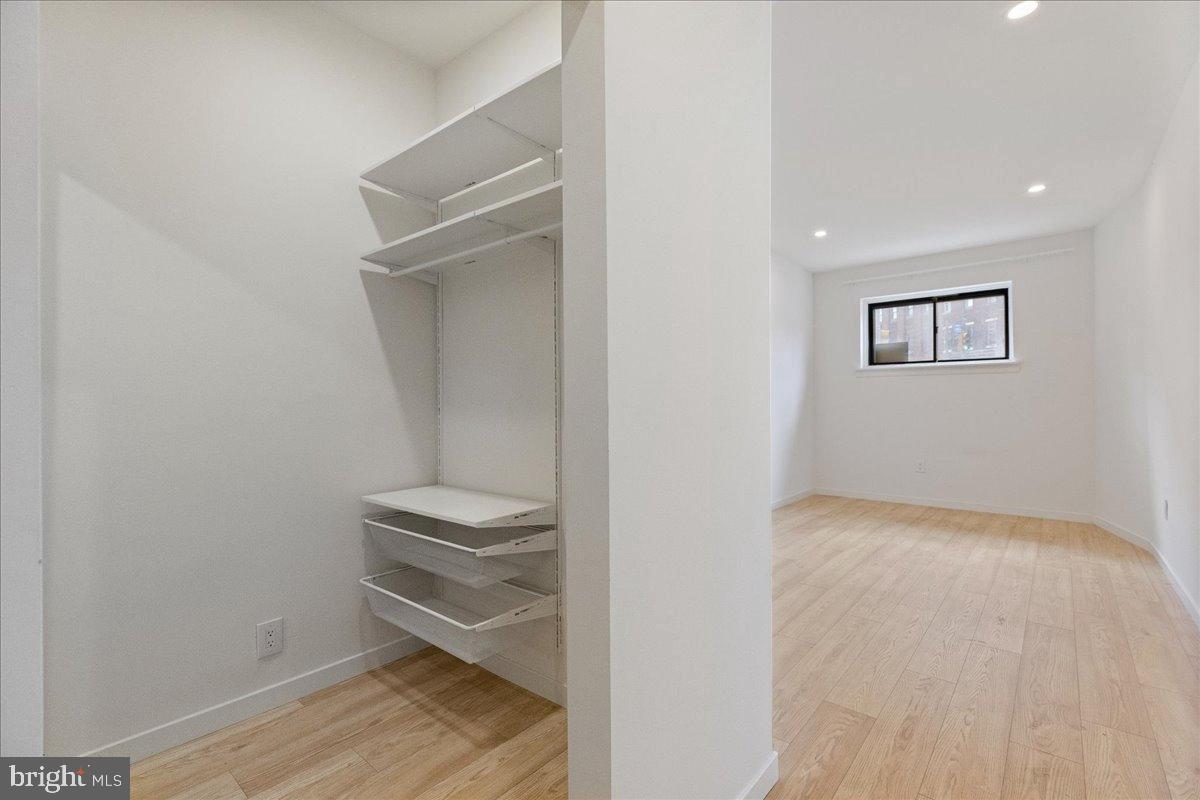 3907 Spring Garden Street, Unit 1 Philadelphia, PA 19104 - Photo 24 of 33 a view of hallway with stairs and wooden floor