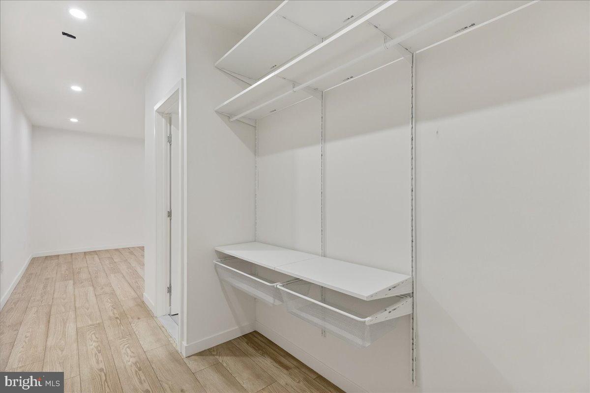 3907 Spring Garden Street, Unit 1 Philadelphia, PA 19104 - Photo 8 of 33 a hallway with stairs and wooden floor