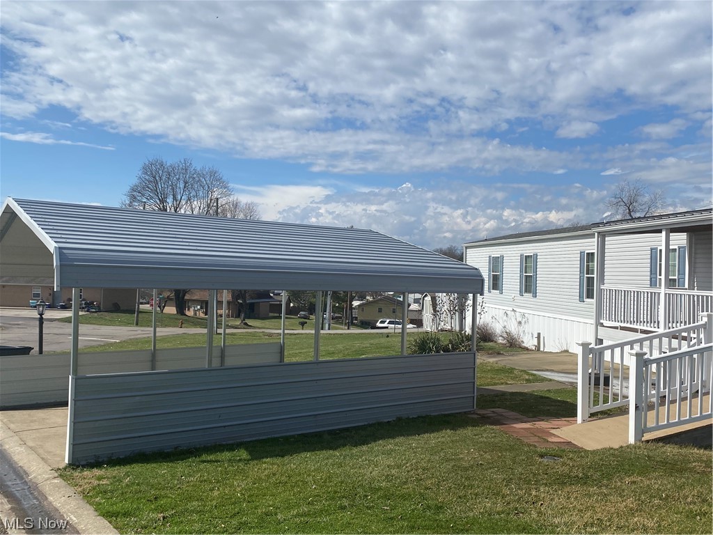 85 Rains Circle Zanesville, OH 43701 - Photo 3 of 15 View of parking featuring a carport and a yard