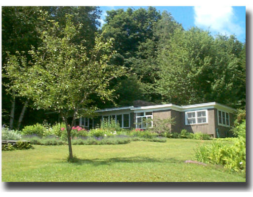 101 Hosmer Road Heath, MA 01340 - Photo 1 of 2 a front view of a house with a garden
