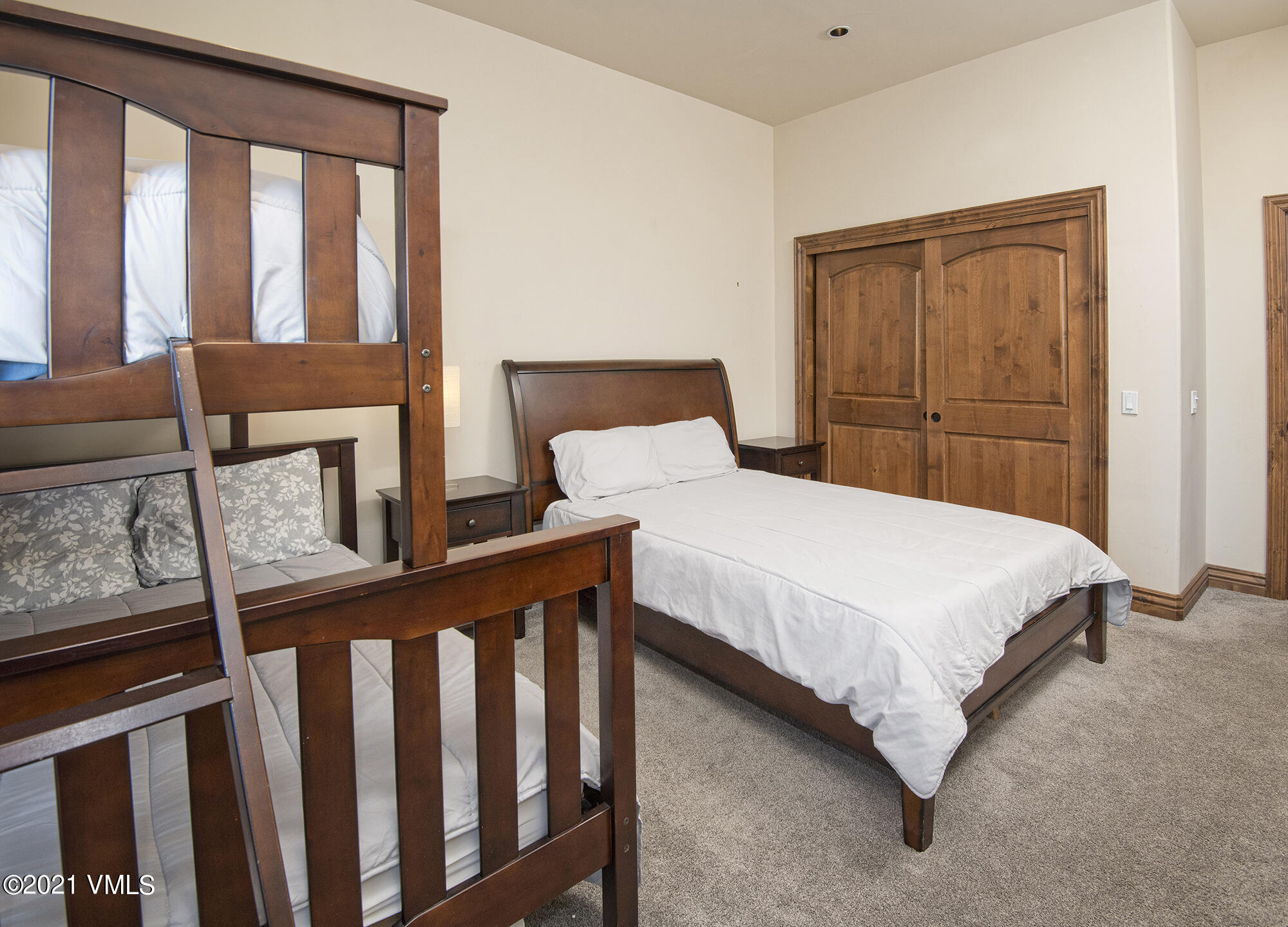 295 Main Street, Unit R201 Edwards, CO 81632 - Photo 19 of 36 a large bed sitting in a bedroom next to a window