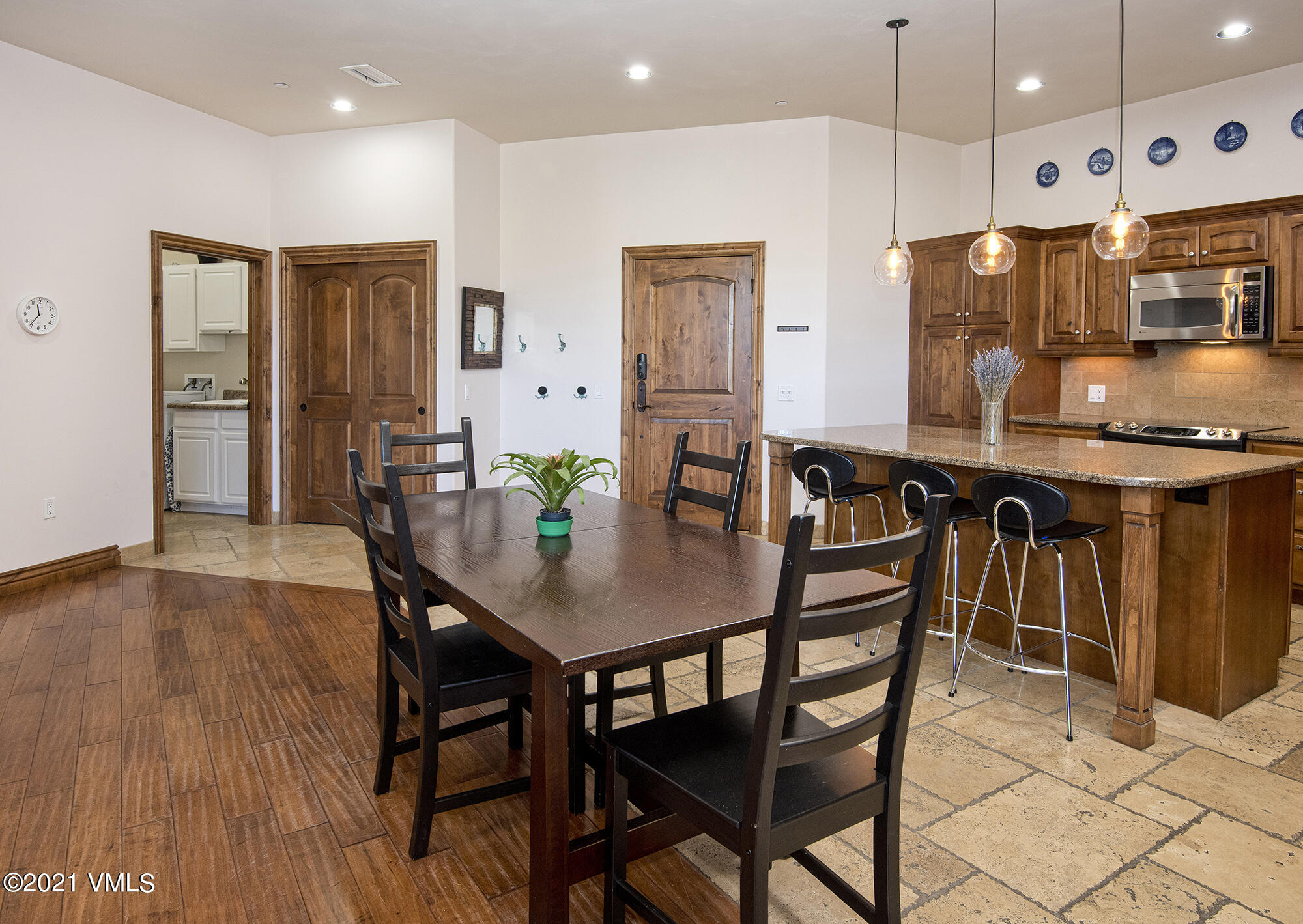 295 Main Street, Unit R201 Edwards, CO 81632 - Photo 7 of 36 a kitchen with stainless steel appliances a dining table chairs and wooden floor