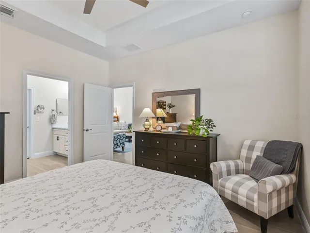 a spacious bathroom with a double vanity sink a mirror a window and a bathtub