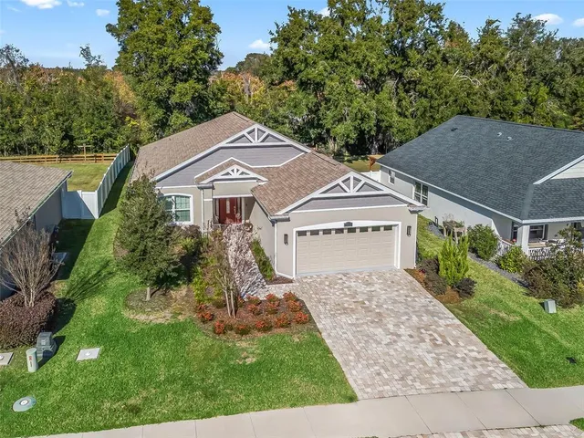 aerial view of a house with a yard