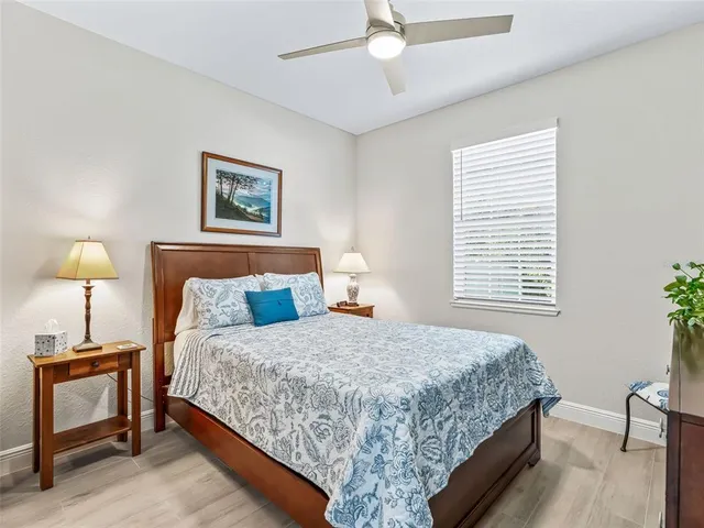 a bedroom with a bed and a lamp on table