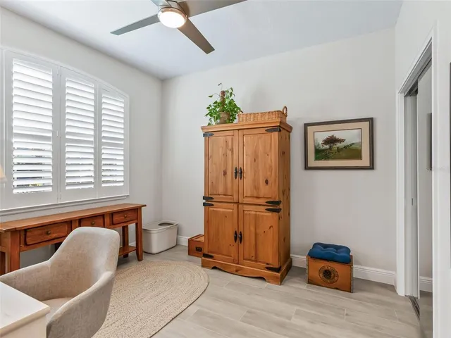 a view of a hallway with closet and a window