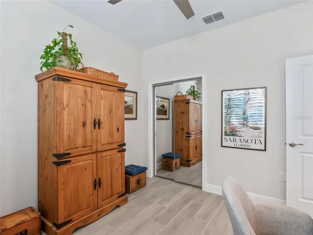 a view of a workspace with furniture and a window