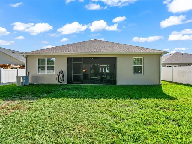 a view of green field with trees in the background