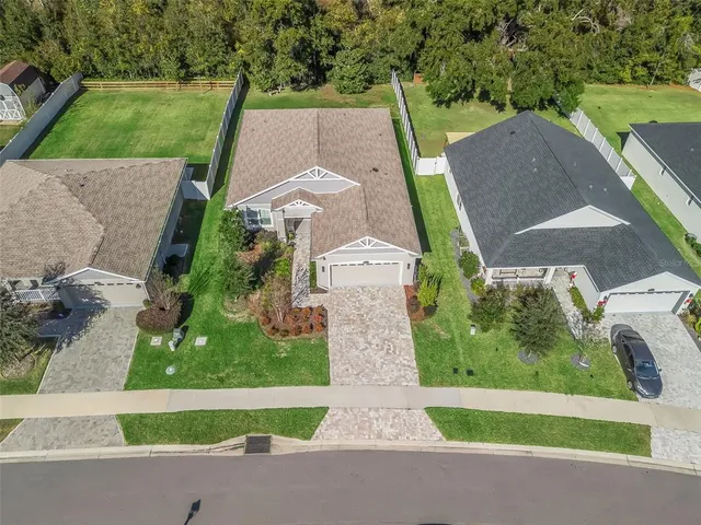aerial view of a house with a yard