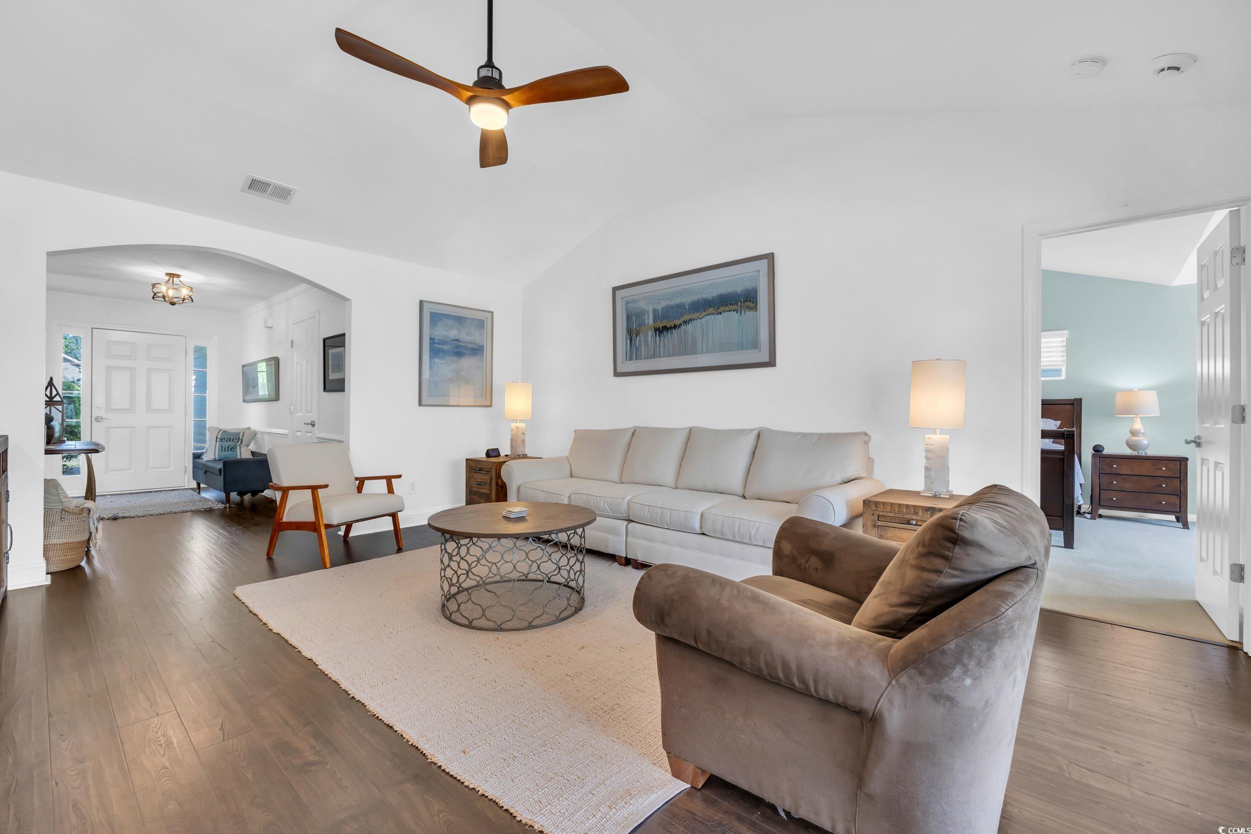 174 Seville Drive Murrells Inlet, SC 29576 - Photo 11 of 40 Living room featuring a ceiling fan, dark wood-typ