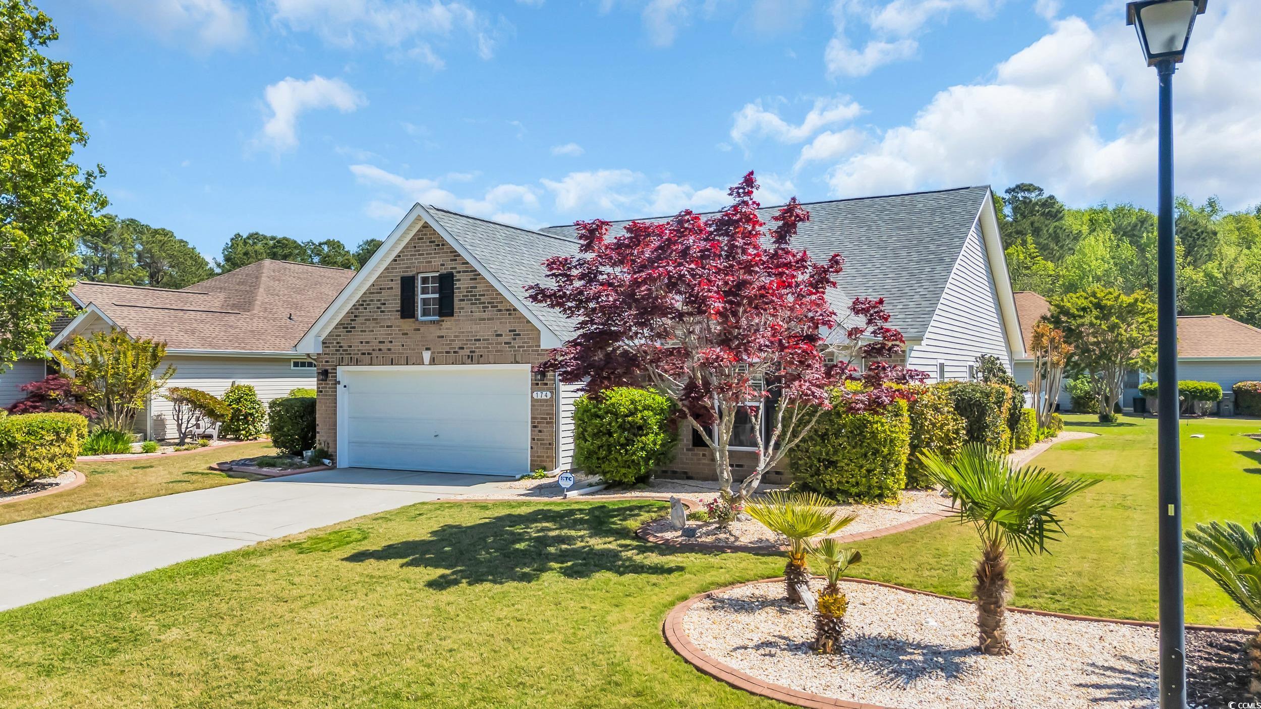 174 Seville Drive Murrells Inlet, SC 29576 - Photo 3 of 40 View of front facade with concrete driveway, a fro