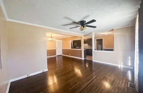 a view of a kitchen with wooden floor and a window