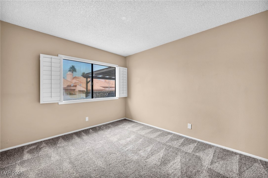 647 Pepper Tree Circle Henderson, NV 89014 - Photo 28 of 34 Bedroom 1 window view of front of property over patio