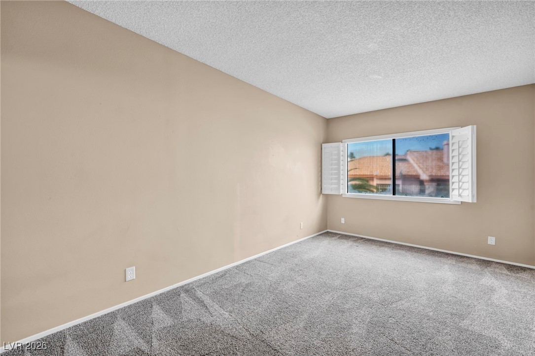 647 Pepper Tree Circle Henderson, NV 89014 - Photo 31 of 34 Bedroom 2 second floor window view of front of property