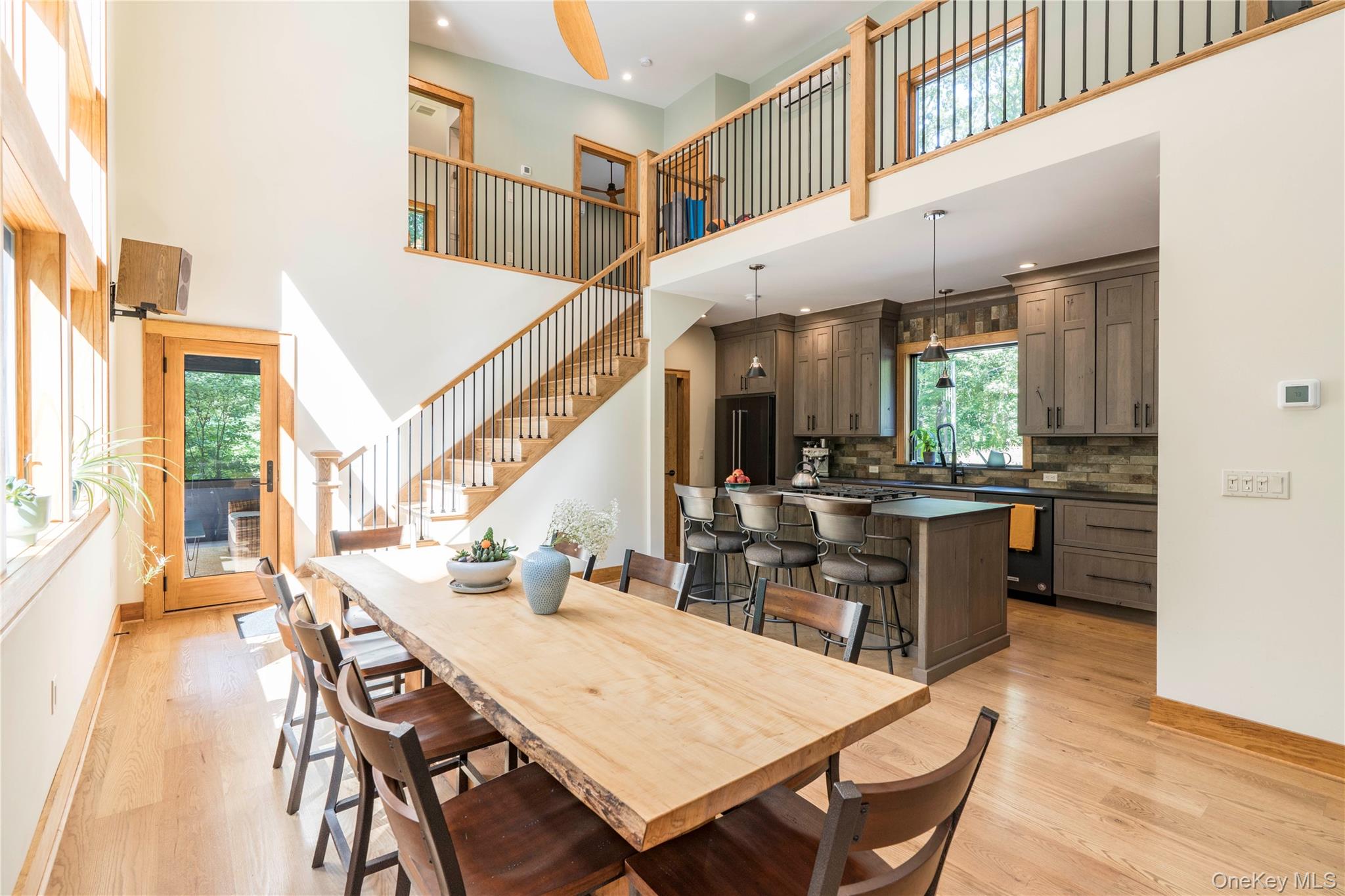 105 Iron Mountain Road Warwick, NY 10990 - Photo 25 of 49 a dining room with a table chairs and a kitchen view