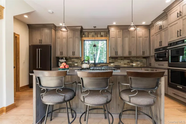 a kitchen with sink stove and cabinets
