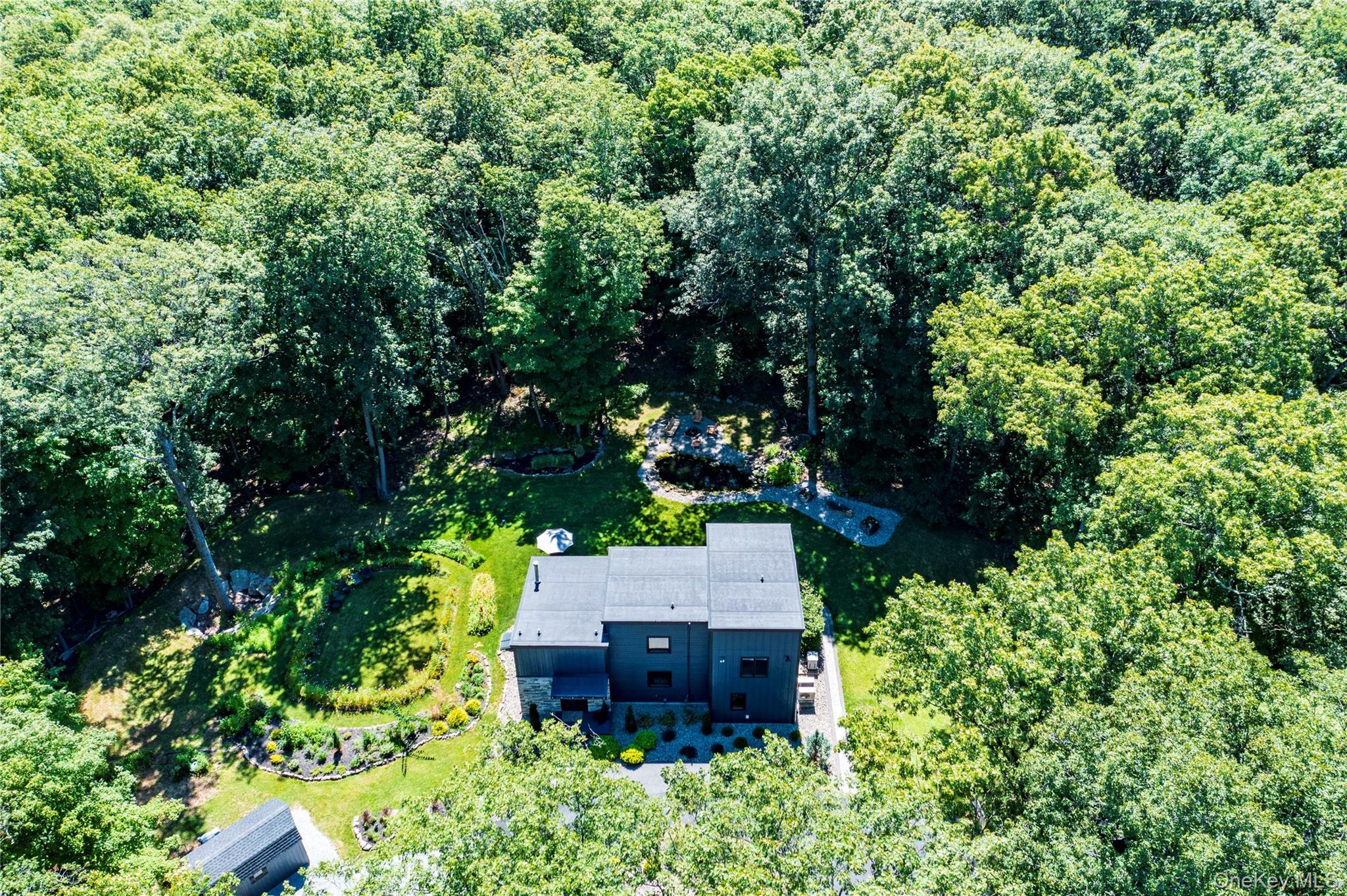 105 Iron Mountain Road Warwick, NY 10990 - Photo 3 of 49 an aerial view of a house with a yard and large trees