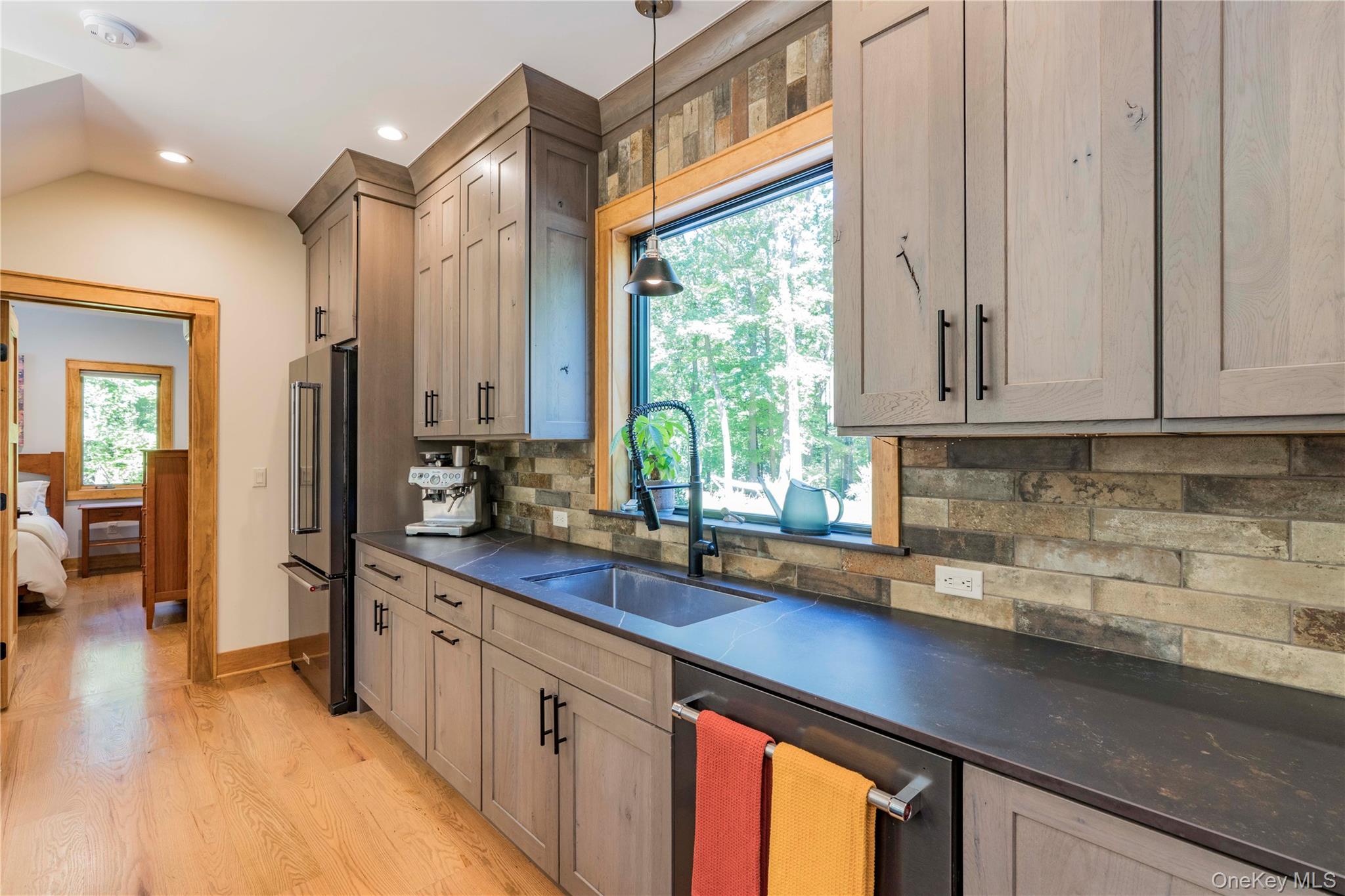 105 Iron Mountain Road Warwick, NY 10990 - Photo 31 of 49 a kitchen with stainless steel appliances white cabinets and a window