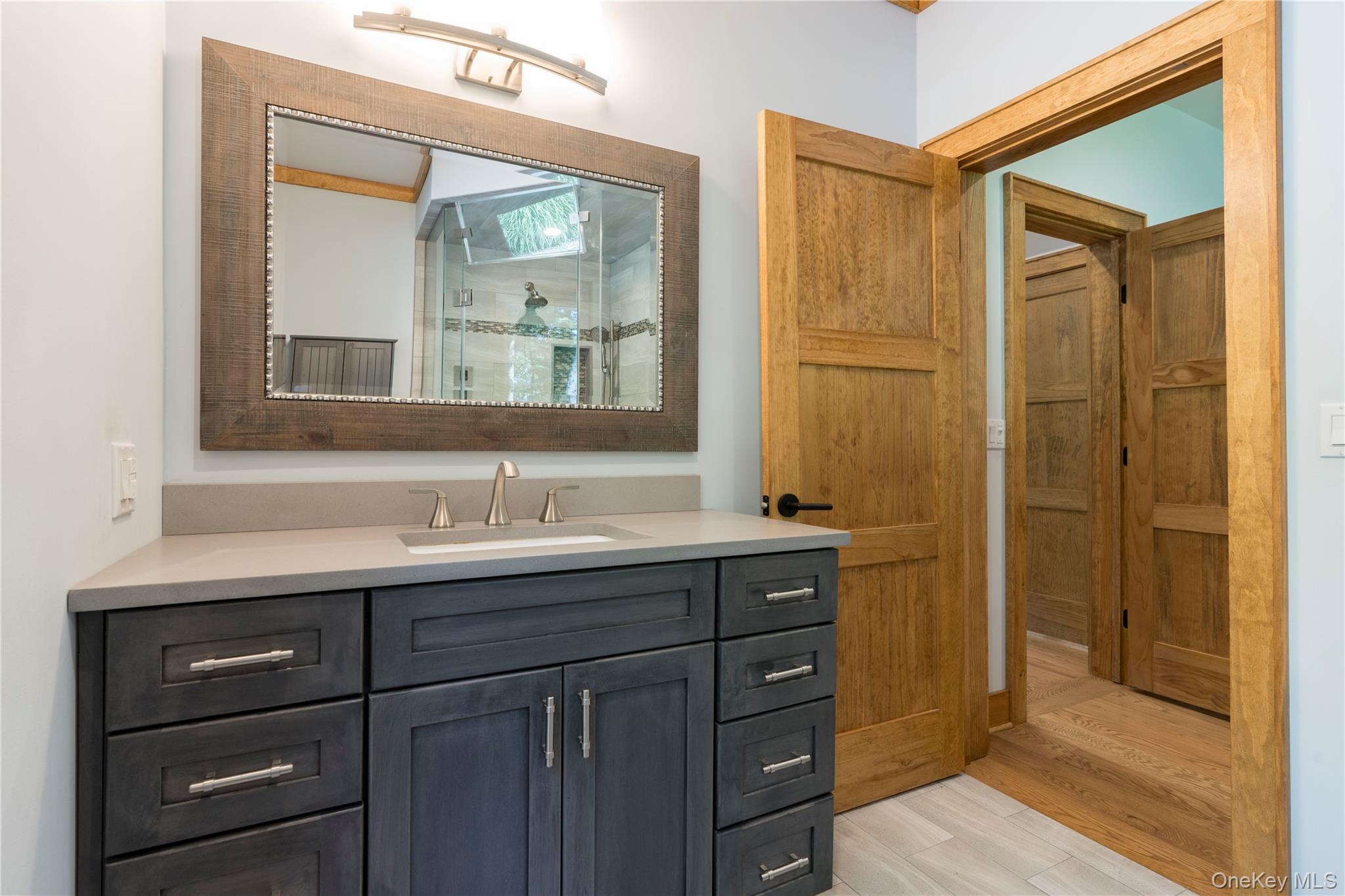 105 Iron Mountain Road Warwick, NY 10990 - Photo 34 of 49 a bathroom with a granite countertop sink mirror and double