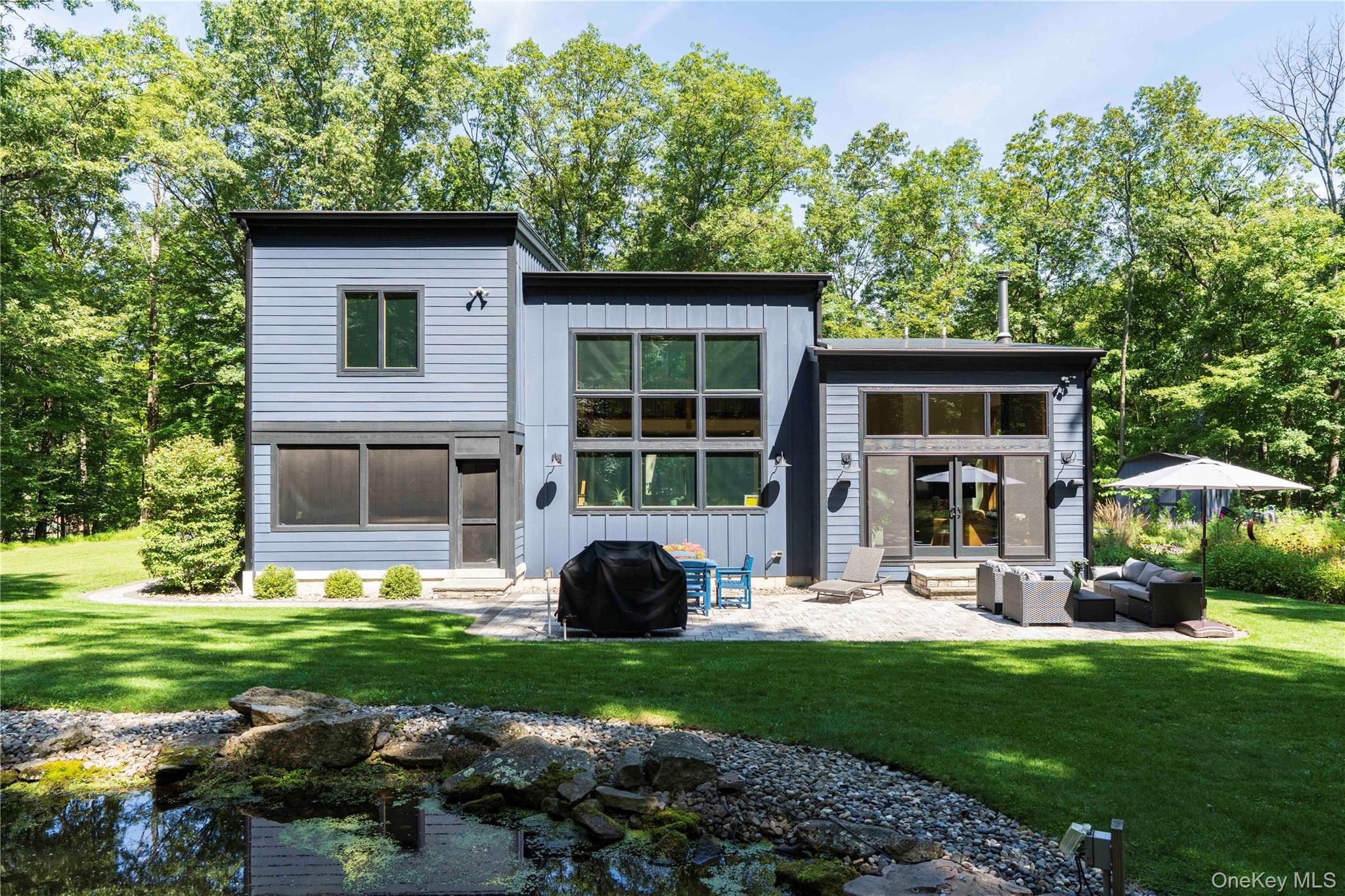 105 Iron Mountain Road Warwick, NY 10990 - Photo 5 of 49 a view of a house with a yard and sitting area