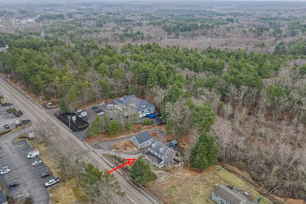 an aerial view of a house with a yard